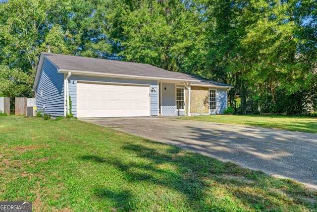 single story home with a garage, central AC, and a front yard