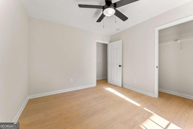 unfurnished bedroom with ceiling fan, a closet, and light wood-type flooring