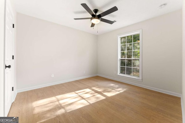 spare room featuring ceiling fan and light hardwood / wood-style flooring