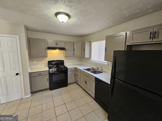 kitchen featuring gray cabinets, sink, light tile patterned floors, and black appliances