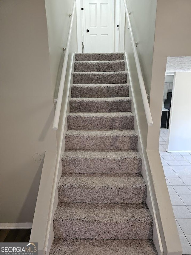 stairs with tile patterned flooring