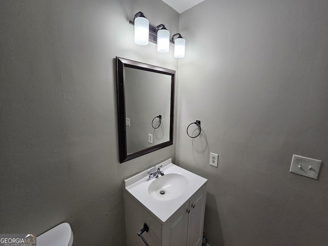 bathroom with vanity and toilet