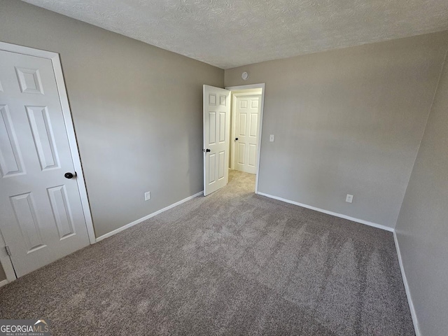 unfurnished bedroom featuring carpet floors and a textured ceiling