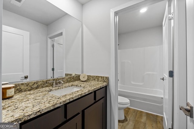 full bathroom with vanity, wood-type flooring, shower / washtub combination, and toilet