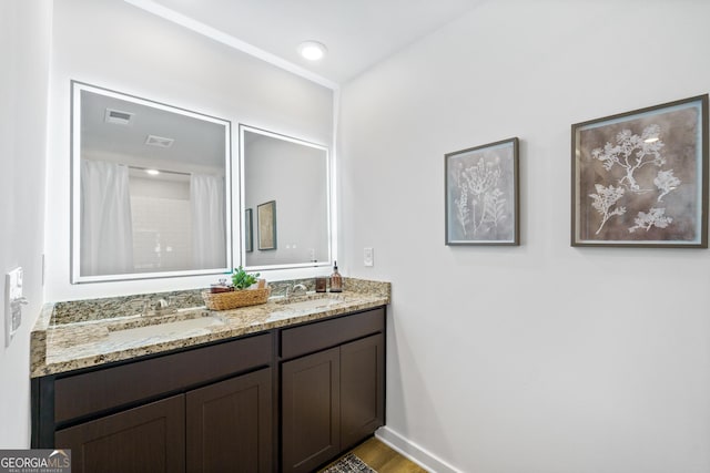 bathroom featuring vanity, hardwood / wood-style flooring, and a shower with shower curtain