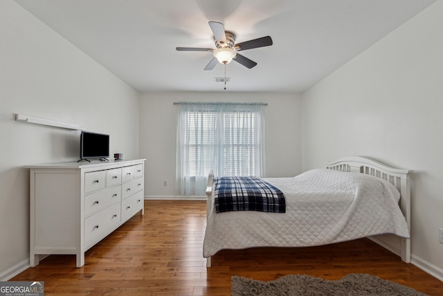 bedroom with ceiling fan and wood-type flooring