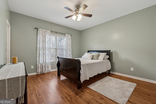 bedroom featuring dark hardwood / wood-style flooring and ceiling fan