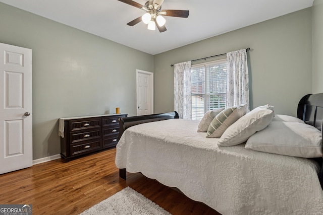 bedroom with hardwood / wood-style flooring and ceiling fan