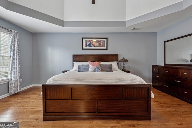 bedroom featuring multiple windows and light hardwood / wood-style floors