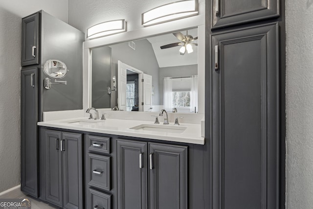 bathroom featuring vaulted ceiling, vanity, and ceiling fan