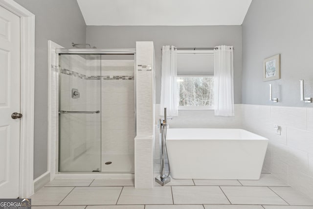 bathroom with tile patterned flooring and plus walk in shower