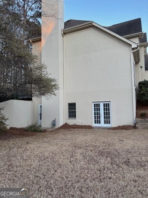 view of side of property featuring french doors