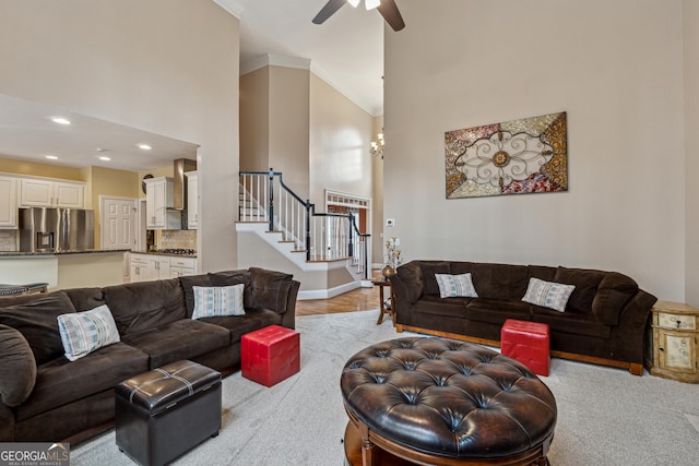 living room with ornamental molding and ceiling fan