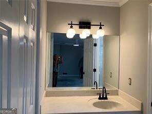 bathroom featuring vanity and ornamental molding