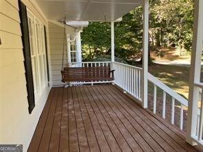 wooden terrace with a porch