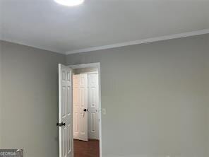 unfurnished room featuring ornamental molding