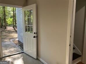 doorway to outside featuring concrete floors