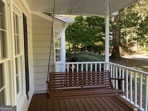 wooden terrace featuring covered porch