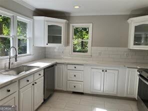 kitchen with white cabinetry, sink, and stainless steel appliances