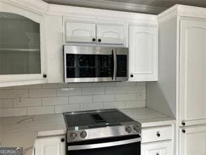 kitchen with white cabinetry and appliances with stainless steel finishes