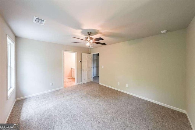 interior space with carpet floors and ceiling fan