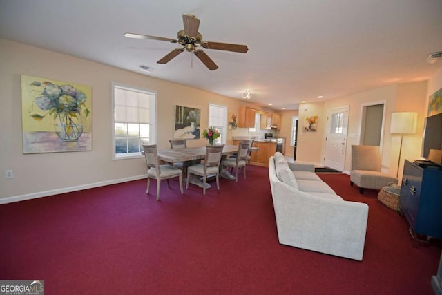 carpeted living room featuring ceiling fan