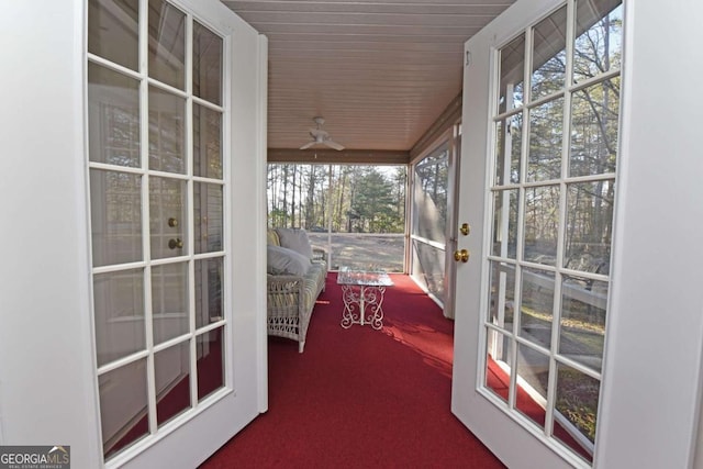 unfurnished sunroom with ceiling fan