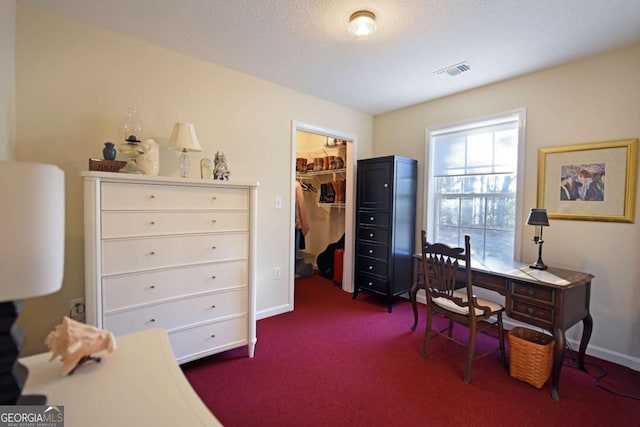 carpeted office space featuring a textured ceiling