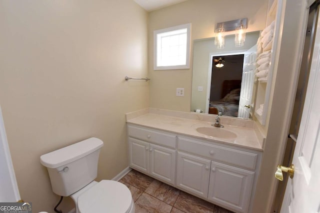 bathroom with ceiling fan, vanity, and toilet