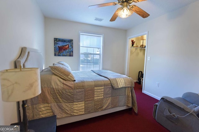 bedroom with ceiling fan, a walk in closet, and a closet