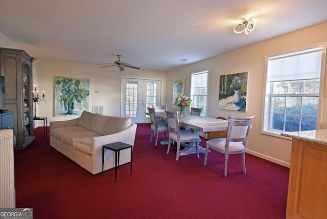 dining space featuring ceiling fan, dark carpet, a textured ceiling, and french doors