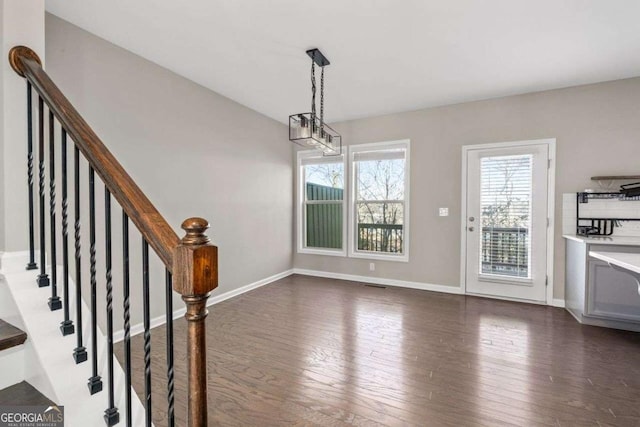 unfurnished dining area with dark hardwood / wood-style floors