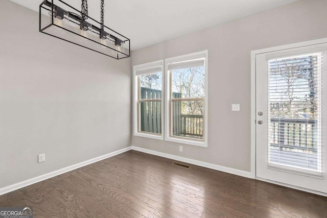 unfurnished dining area with dark hardwood / wood-style floors