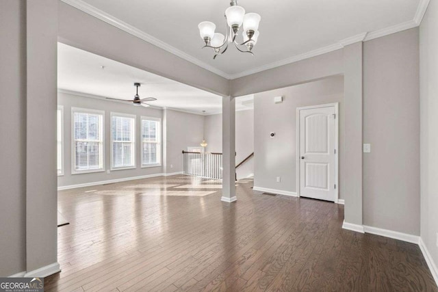 unfurnished living room featuring ceiling fan with notable chandelier, dark wood-type flooring, and ornamental molding