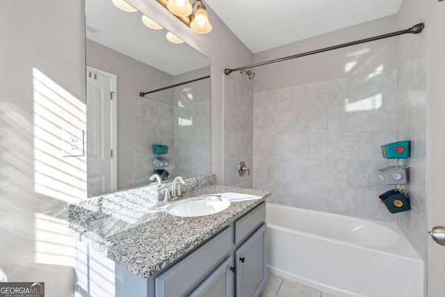 bathroom featuring tiled shower / bath combo, vanity, and tile patterned floors