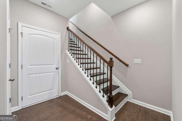 stairs featuring hardwood / wood-style flooring