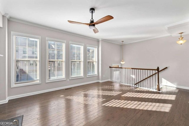 unfurnished room with ceiling fan, crown molding, a wealth of natural light, and dark wood-type flooring