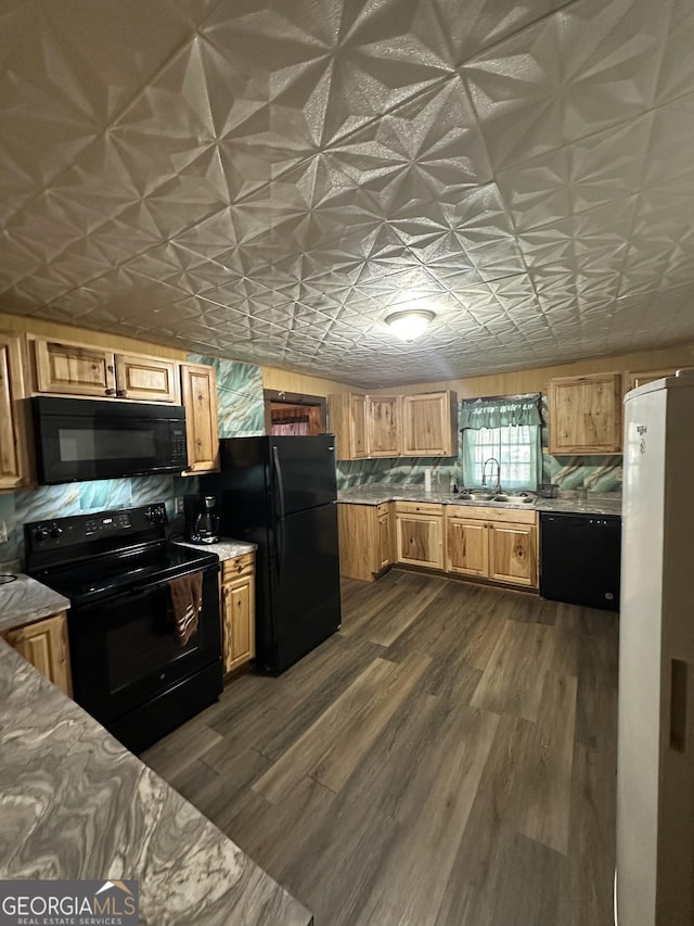 kitchen with dark hardwood / wood-style floors, sink, and black appliances