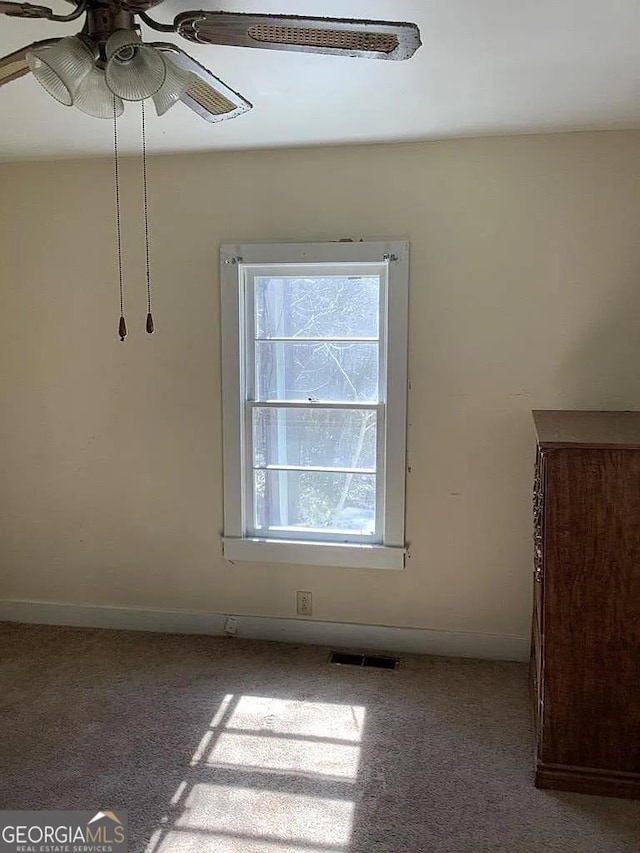 carpeted empty room with ceiling fan