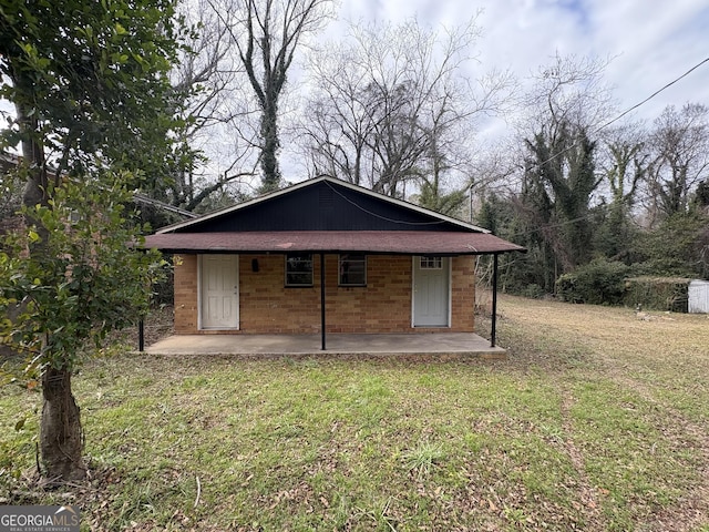 back of property featuring a yard and a patio area