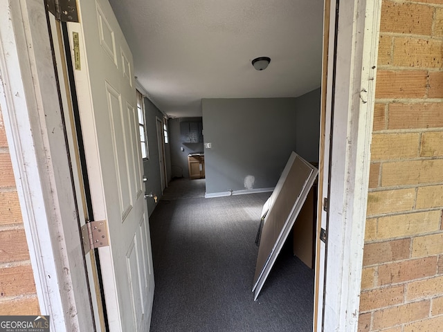 hallway featuring carpet