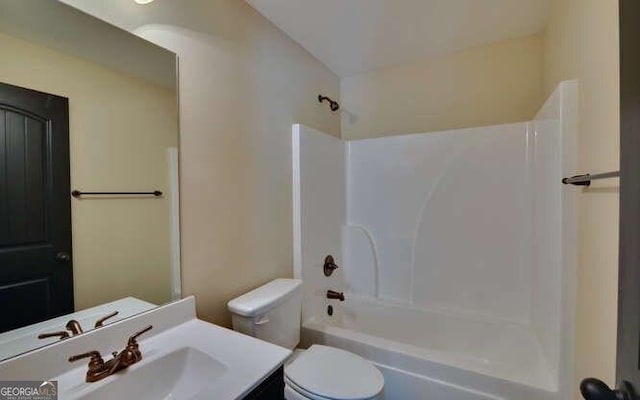 full bathroom featuring vanity, bathtub / shower combination, and toilet