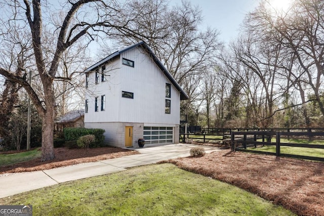 view of home's exterior featuring a garage and a yard