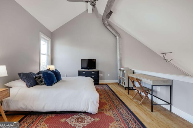 bedroom featuring hardwood / wood-style flooring, vaulted ceiling with beams, and ceiling fan