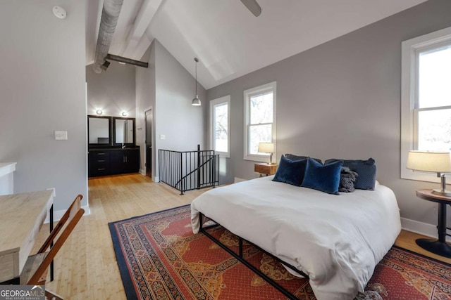 bedroom featuring beamed ceiling, ceiling fan, high vaulted ceiling, and light hardwood / wood-style floors