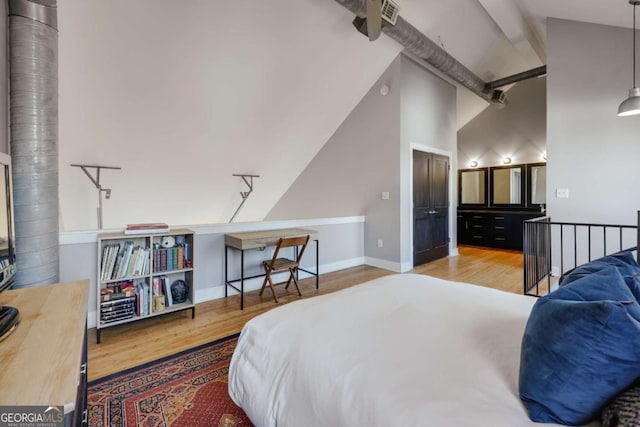 bedroom featuring lofted ceiling and hardwood / wood-style flooring