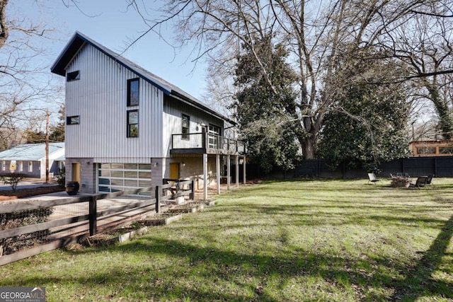 view of side of property featuring a garage and a lawn