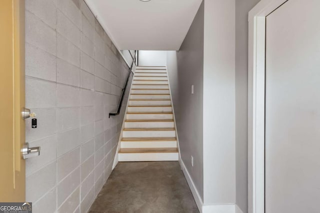 stairs featuring concrete floors