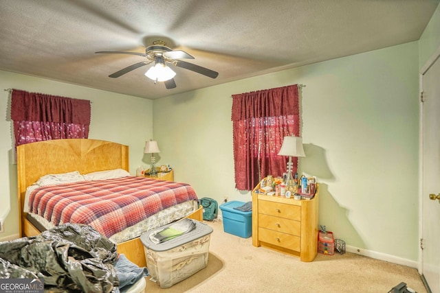 bedroom with a textured ceiling, ceiling fan, and carpet