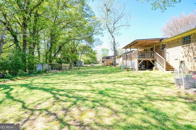 view of yard featuring a shed and a wooden deck